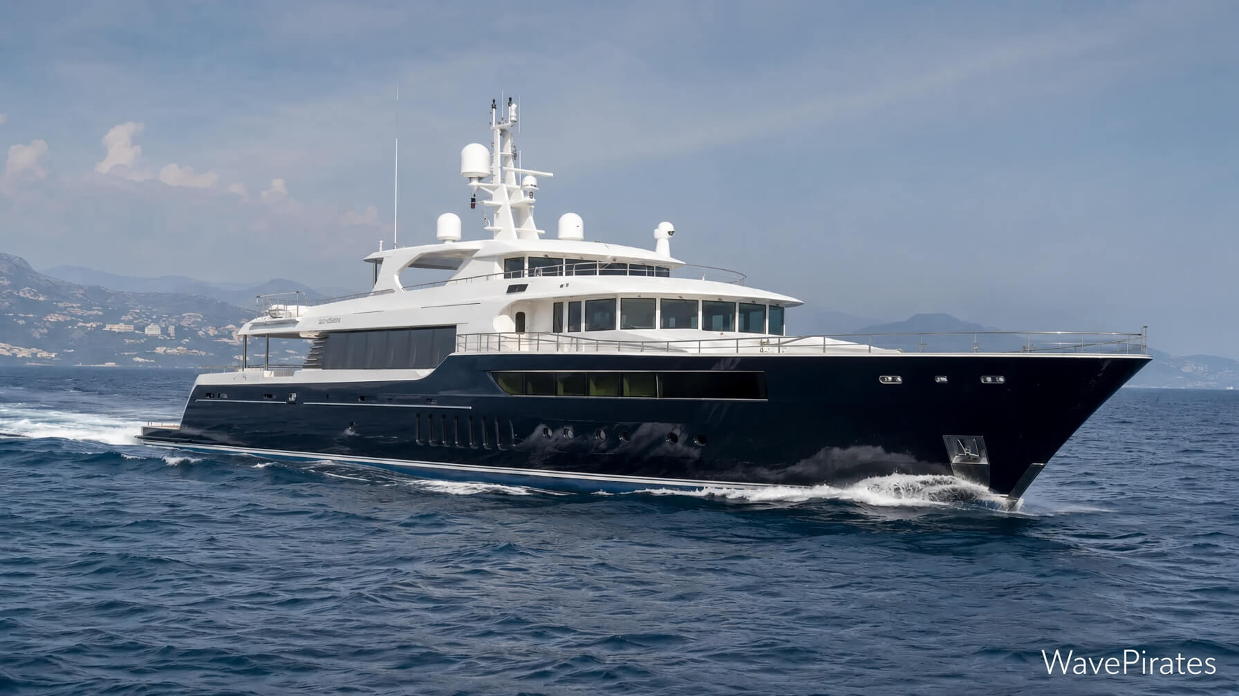Dark-hulled motor yacht underway at sea