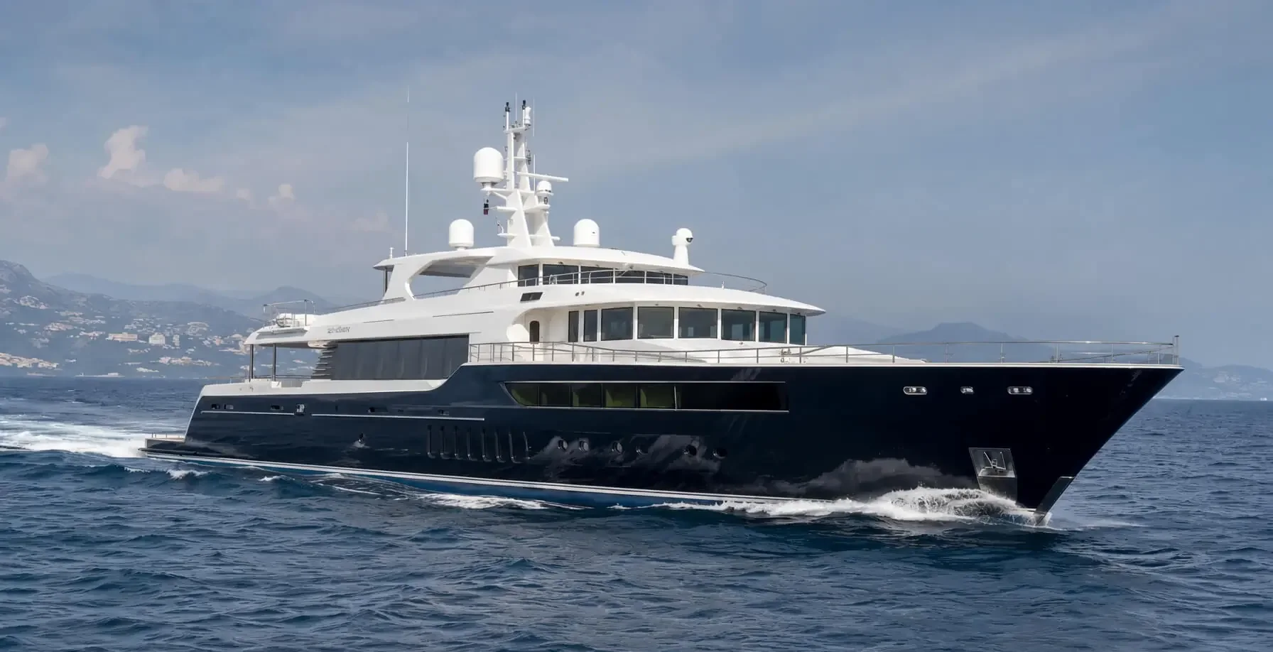 Dark-hulled motor yacht underway at sea