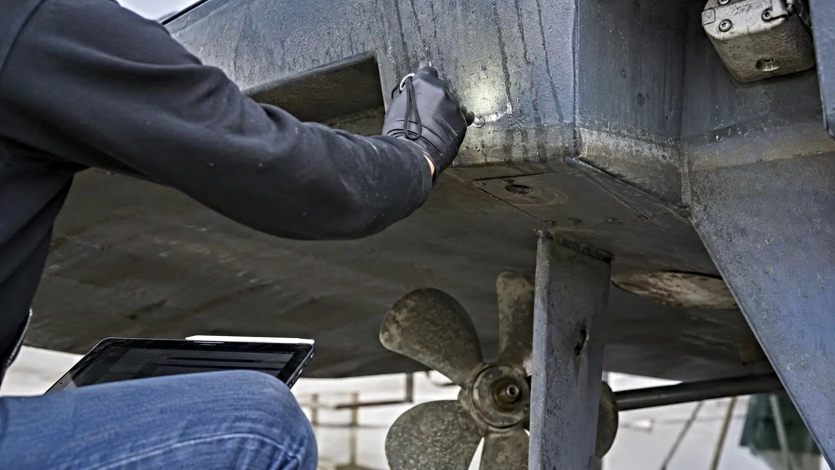Marine technical surveyor performing structural condition inspection