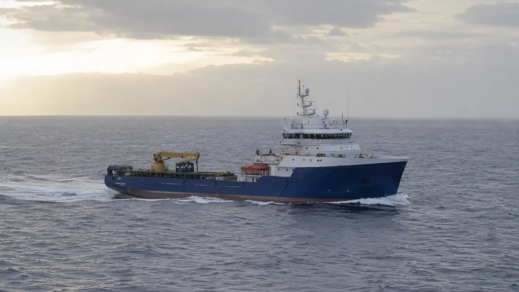 Superyacht anchored in coastal bay — strategic maritime consultancy